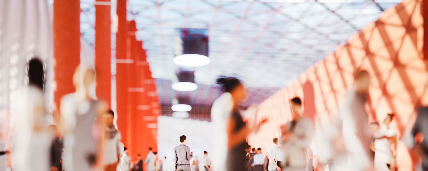 Conference attendees walking through an event hall.